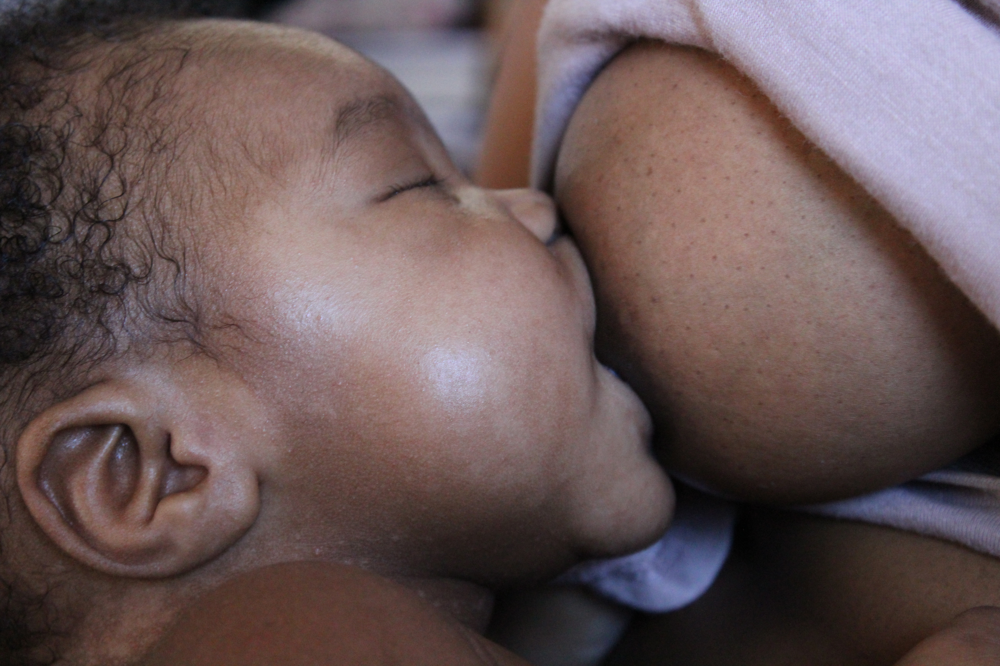 cropped-image-mother-breastfeeding-newborn-son-home